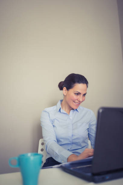 istock Businesswoman use laptop in an office. She is focused on her work 1032492944