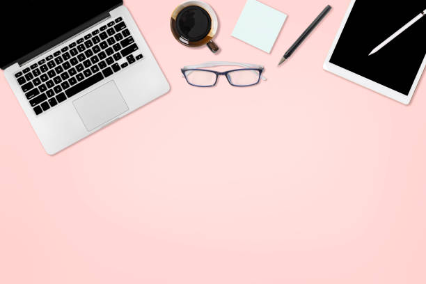 istock Flat lay photo of office table with laptop computer, digital tablet, mobile phone and accessories. on isolated pink background. Desktop office mockup concept. 1032495876