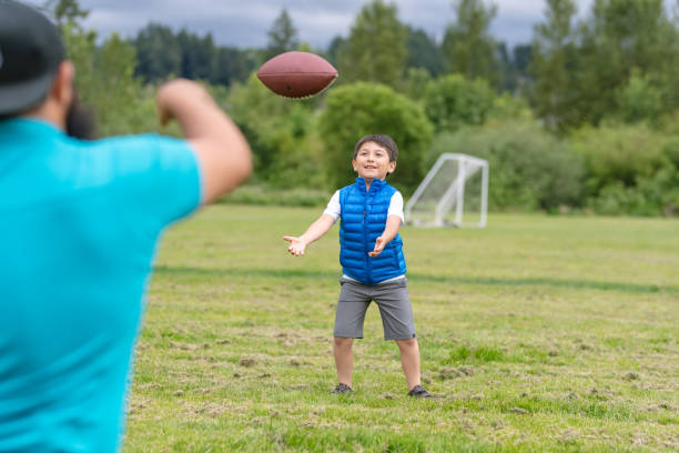 istock Young Native American boy plays football with his dad 1032496484