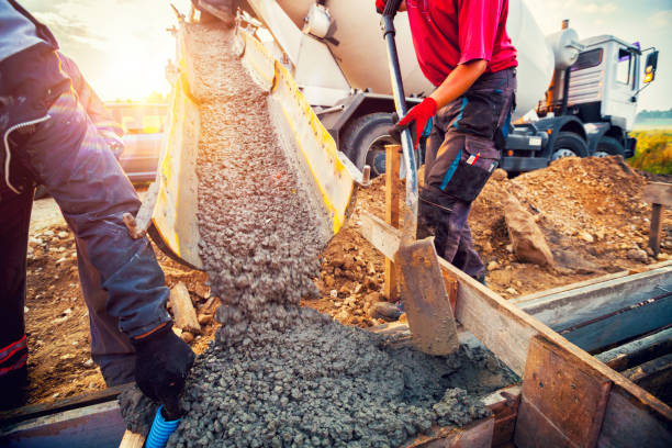 Pouring concrete to the foundations of the building Pouring concrete to the foundations of the building. Construction Worker Guiding Cement Mixer Truck Trough. Cement Pouring from a Mixer Truck Chute. Concrete Foundation Construction. concrete work stock pictures, royalty-free photos & images