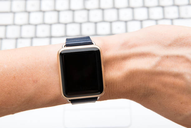 istock Woman using smartwatch against her laptop 1032501192
