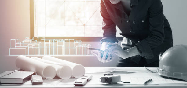 istock Concept architects,engineer using mobile phone with a blueprint in the office, Vintage, Sunset light.Selective Focus 1032507670