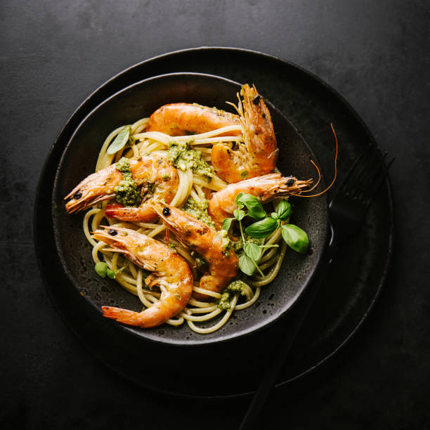 istock Spaghetti with pesto and prawns served on plate 1032508954