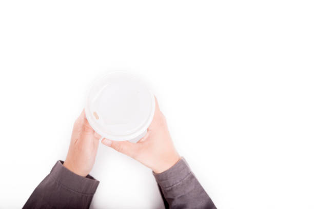 istock hand hold paper coffee cup in white background. flat lay, top view 1032509486