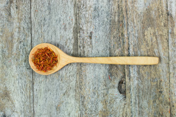 istock safflower in wood spoon on table 1032509866