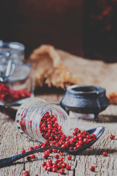 istock Pink pepper rose in a glass jar and spoon 1032512238