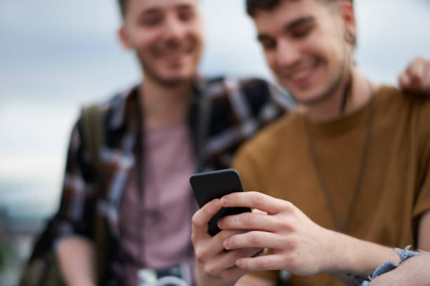 istock Gay couple with mobile phone 1032516456