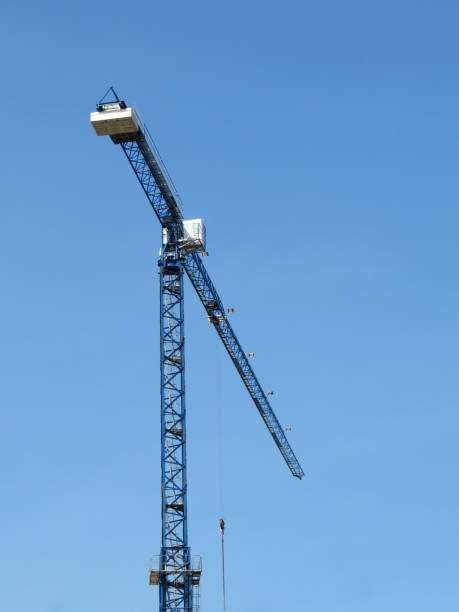 istock Construction crane on background of clear blue sky 1032516468