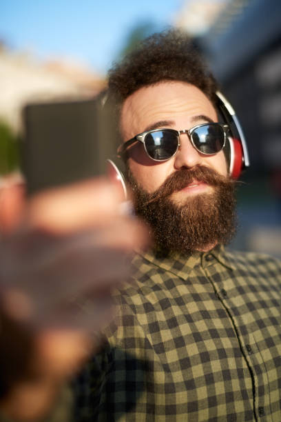 istock Male hipster person taking selfie image 1032517890