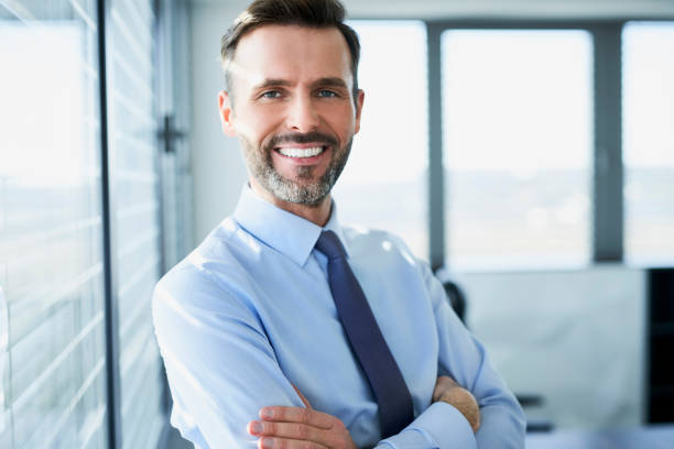 istock Middle-aged businessman smiling at camera while in his office 1032536180