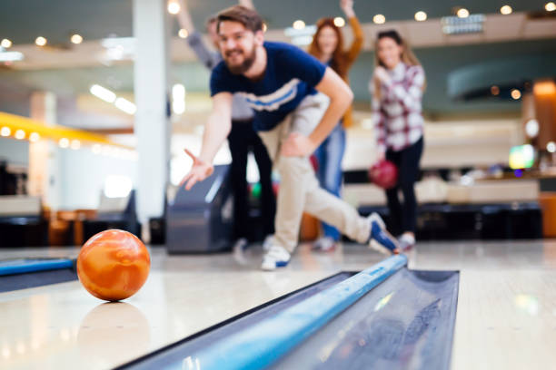istock Friends enjoying bowling at club 1032538384