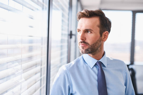 Businessman standing at office looking out the window