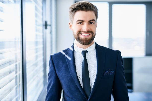 istock Young successful employee looking straight at camera in his office 1032539118