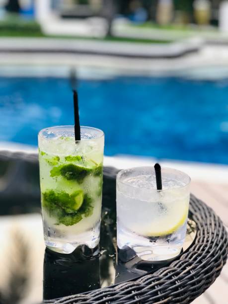 istock pool with mojito annd gin fizz cocktail,luxury setting 1032539214