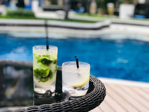 istock pool with mojito annd gin fizz cocktail,luxury setting 1032539230