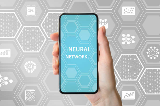 istock Deep neural network concept. Hand holding modern bezel free smart phone in front of neutral background with icons 1032544366