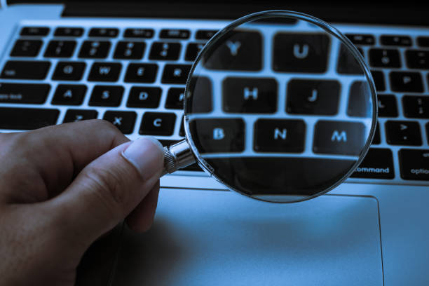 istock Magnifying Glass With Laptop Background 1032544526