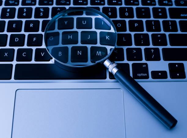 istock Magnifying Glass With Laptop Background 1032544546