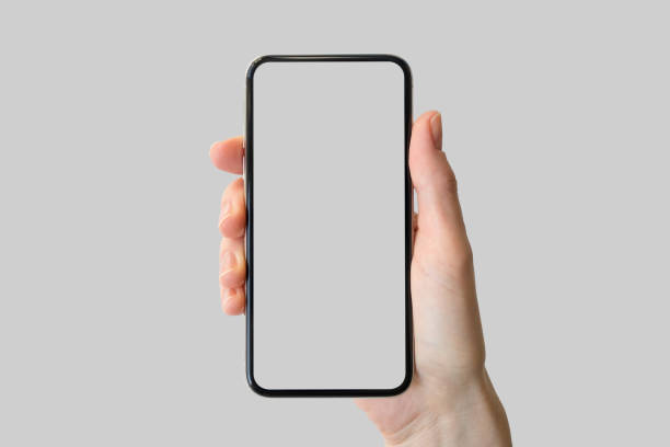 istock Hand holding bezel-free / frameless modern smartphone in front of neutral background 1032544622