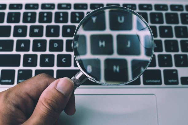istock Magnifying Glass With Laptop Background 1032544662