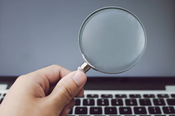 istock Magnifying Glass With Laptop Background 1032544744