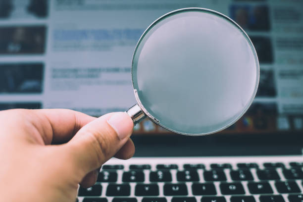 istock Magnifying Glass With Laptop Background 1032544754