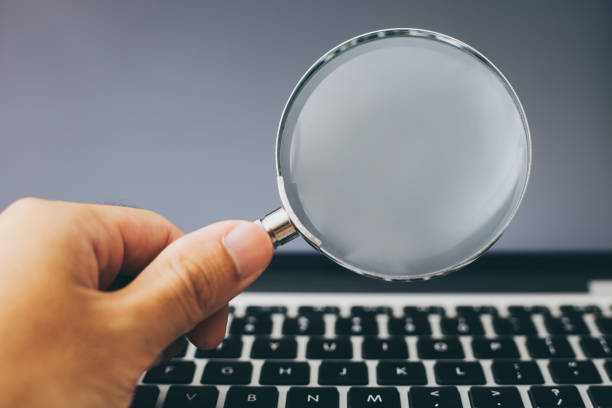 istock Magnifying Glass With Laptop Background 1032544772