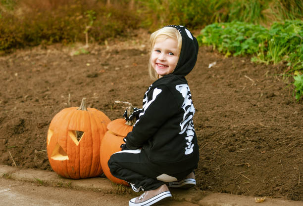 istock smiling child with Halloween pumpkin Jack O