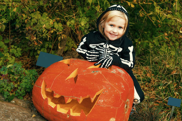 istock happy child with huge Halloween pumpkin Jack O
