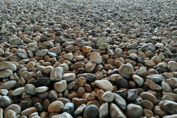 istock gravel on ground construction material for reference. ground and sub base layer of floor. river stone smooth curve edge stone. 1032548354