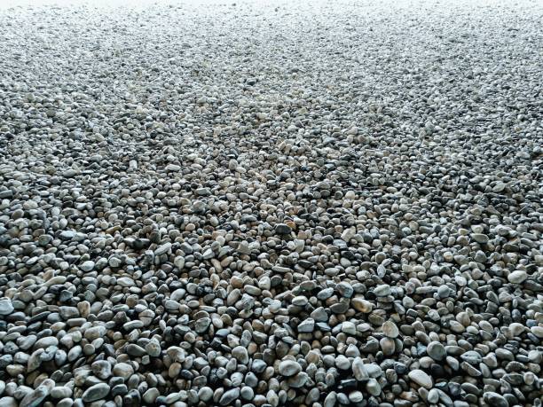 gravel on ground construction material for reference. ground and sub base layer of floor. river stone smooth curve edge stone.