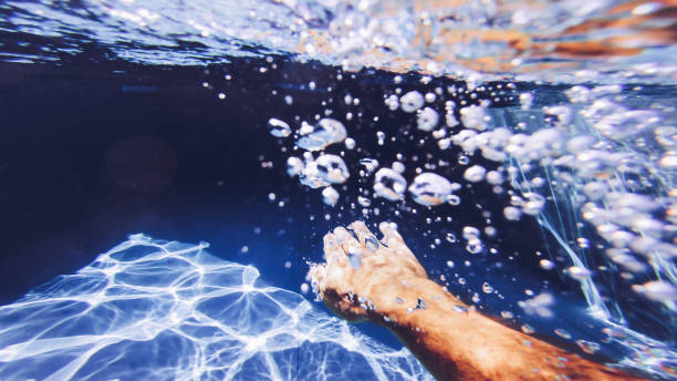 istock Man swimming POV in a swimming pool: summer relax 1032548854