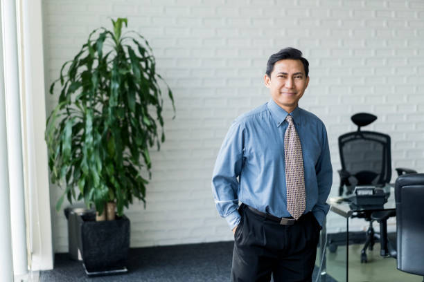 istock Businessman standing with hands in pockets 1032549434