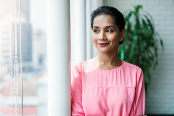 istock Thoughtful businesswoman looking away by window 1032552204