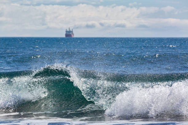 istock The wave rolls ashore on the background of the ship 1032553296