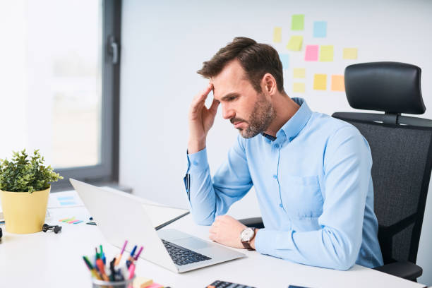 istock Worried businessman working on laptop at office 1032555724