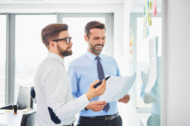 istock Two coworkers discussing business strategy during meeting in office 1032557006