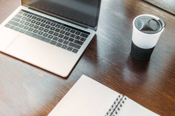 istock high angle view of laptop and cup of coffee on table in office 1032560048
