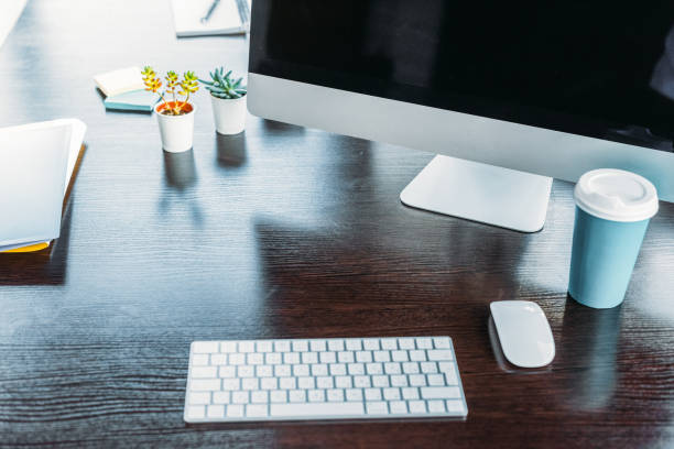 istock table with computer and cup of coffee in office 1032560058