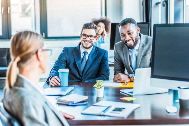 istock smiling multicultural businessmen looking at colleague in office 1032560126