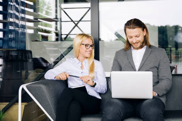 istock Business couple working together on project at modern startup office 1032560966