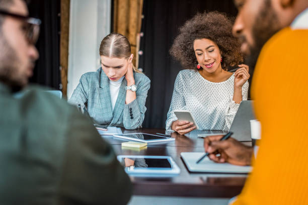 istock multicultural businesspeople with gadgets on table in office 1032561604