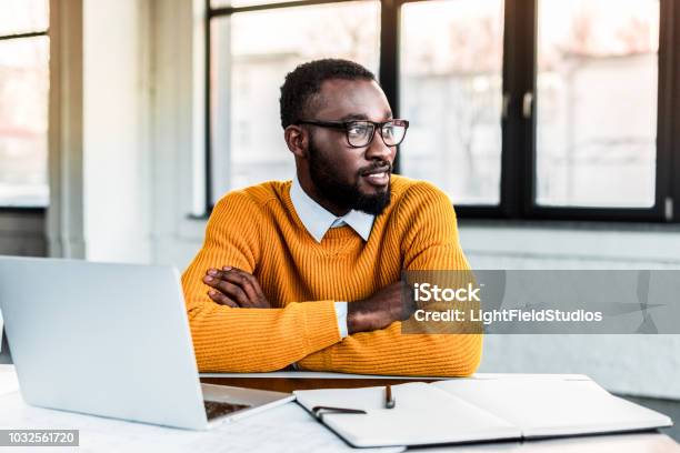 Smiling African American Businessman With Crossed Arms In Office Stock Photo - Download Image Now