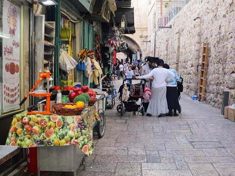 Jerusalem, Israel - 09 23 2017: Arab Palestinian people are shopping at the Jerusalem Old City bazaar market. Arab market is located in Jerusalem Old City - home to several sites of key religious importance.