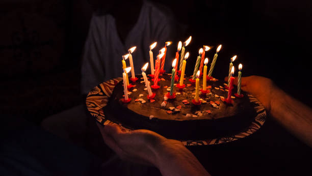 istock birthday surprise cake with candles in darkness 1032567496