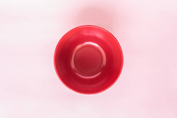 istock red bowl top view on pink background 1032568036