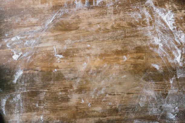 top view of rustic wooden table covered with flour top view of rustic wooden table covered with flour flour photos stock pictures, royalty-free photos & images