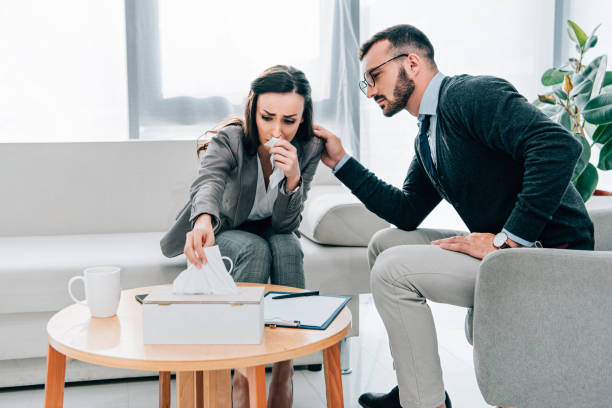istock psychologist touching shoulder of crying patient in doctors office 1032577610