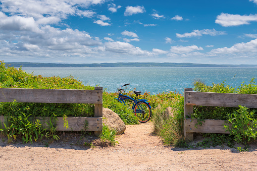 Two bicycles on the beach trail at sunny summer day in Cape Cod beach, Massachusetts.