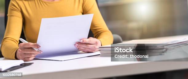 Businesswoman Checking Document Stock Photo - Download Image Now - Document, Reading, Examining